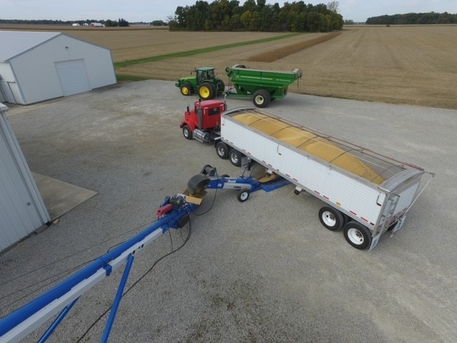 Corn being loaded into silo from a large truck