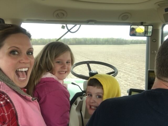 Doug Longfellow and family riding the tractor